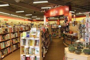 Cozy bookstore interior with shelves of books and warm lighting.
