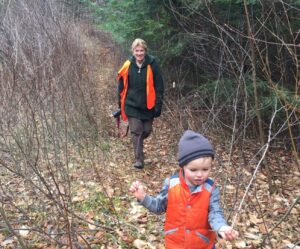 Cheryl Charles and a small boy walking in a forest