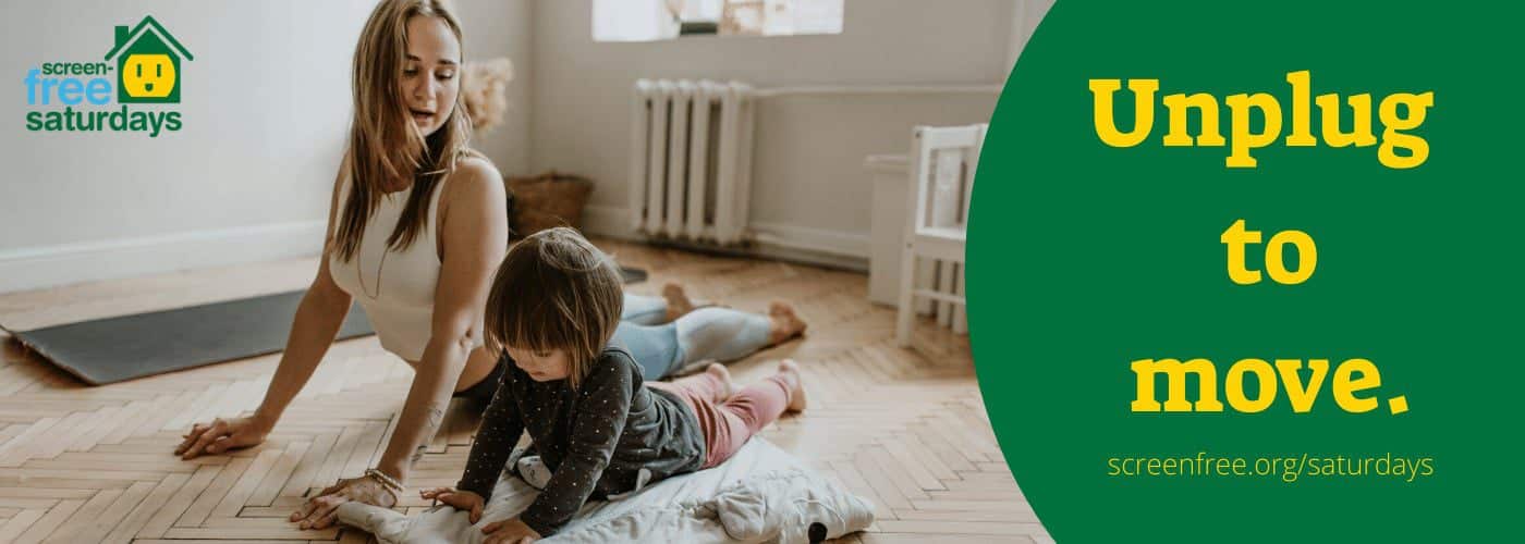 Mother and child doing yoga together indoors.