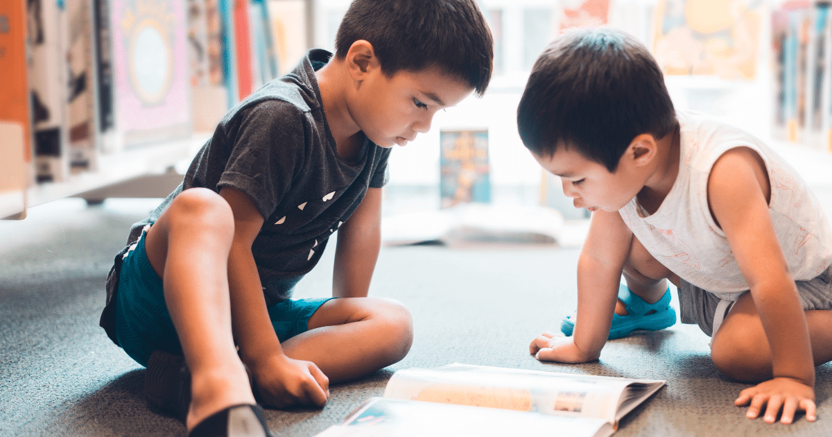 Two children focused on a board game indoors.